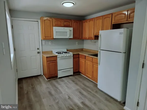 a kitchen with stainless steel appliances granite countertop a refrigerator a stove a sink and a microwave