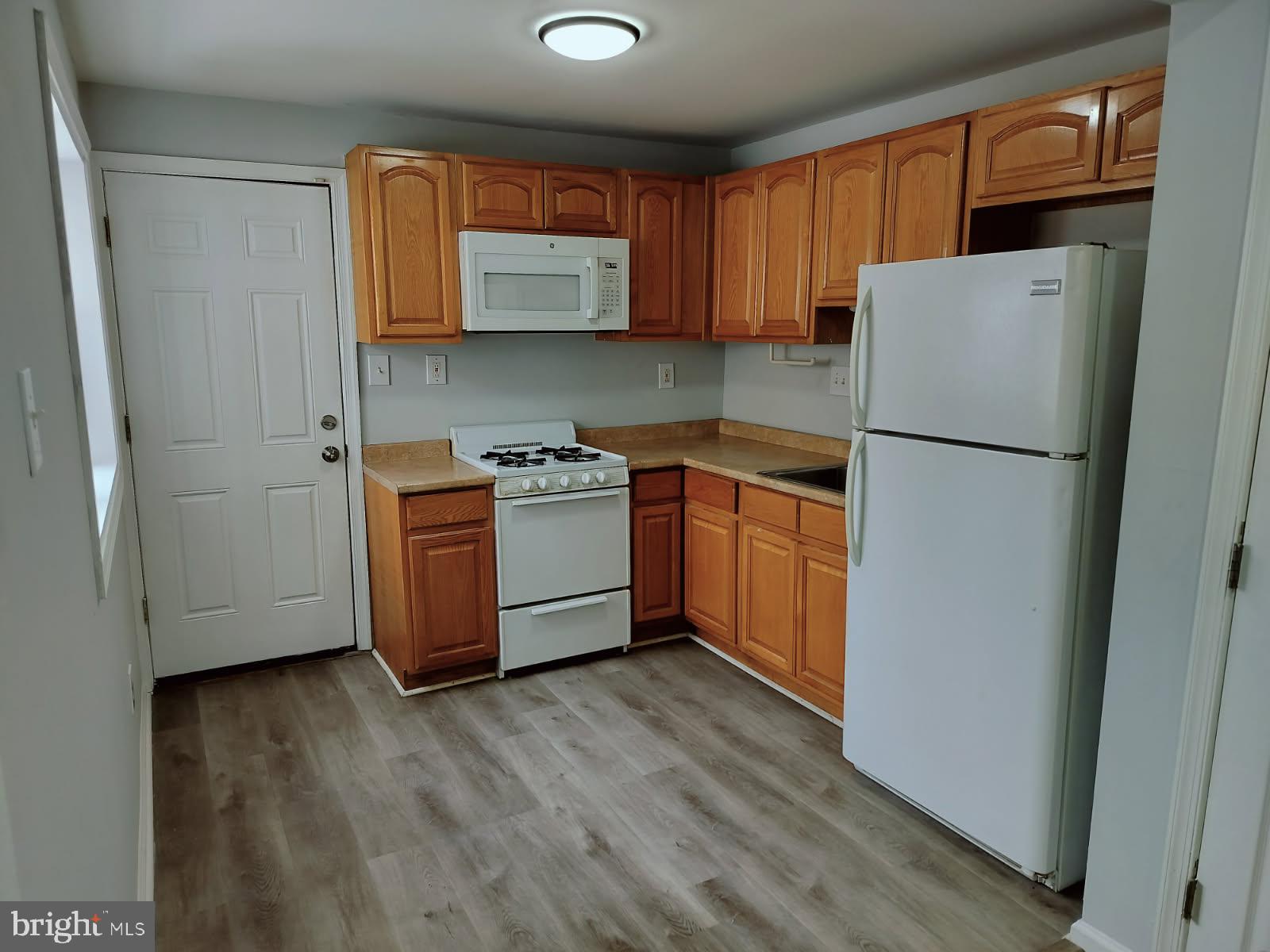 2143 South Beechwood Street Philadelphia, PA 19145 - Photo 5 of 14 a kitchen with stainless steel appliances granite countertop a refrigerator a stove a sink and a microwave