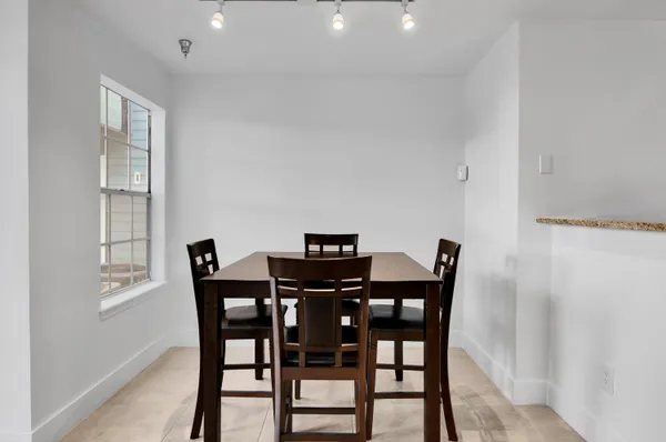 a view of a dining room with furniture and window