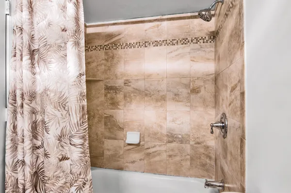a bathroom with a glass shower door