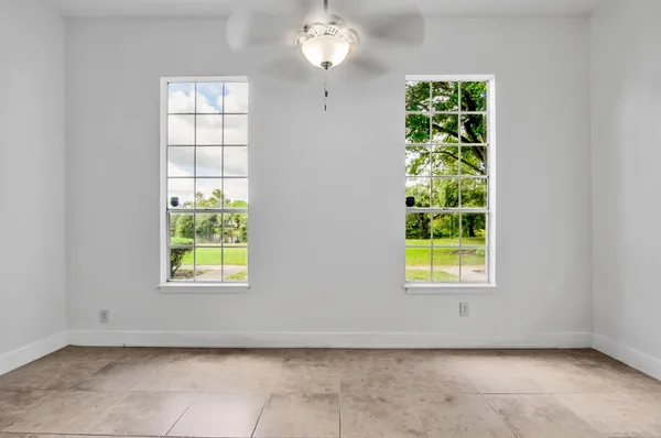 an empty room with windows and closet