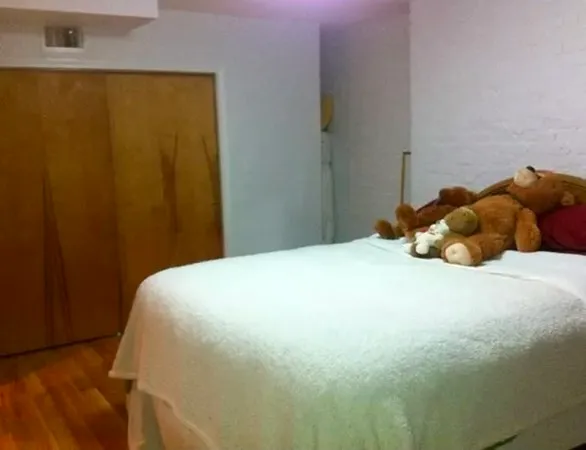 a bed sitting in a bedroom next to a wooden door