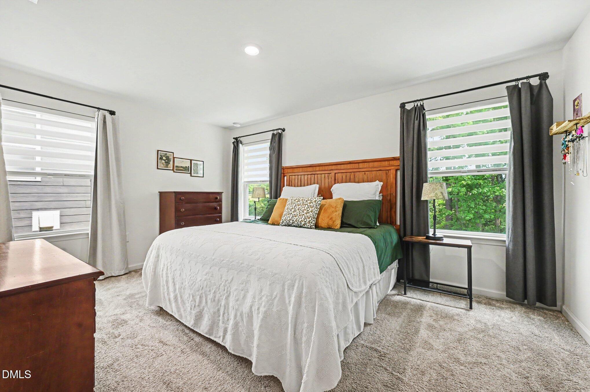 574 Hacksaw Trail Raleigh, NC 27610 - Photo 11 of 28 a bedroom with a large bed and a large window