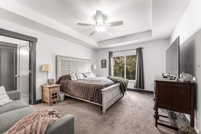 313 Old Maple Road South Weber, UT 84405 - Photo 14 of 35 Spacious room featuring a decorative headboard, tray ceiling, recessed lighting, and a ceiling fan