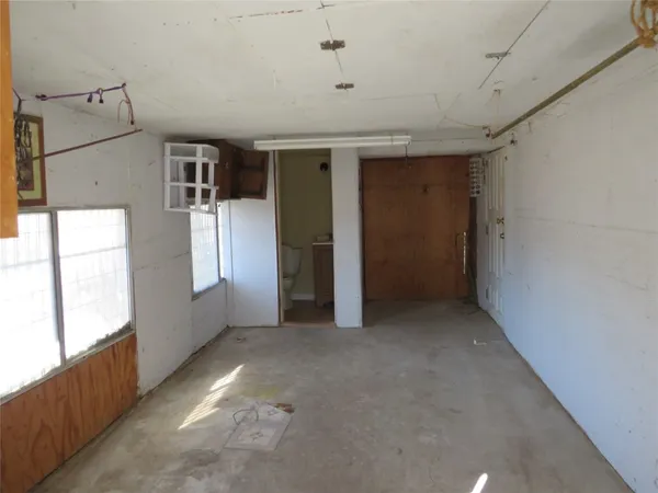 a view of a big room with windows and chandelier