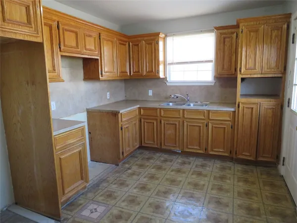 a kitchen with stainless steel appliances granite countertop a sink stove and granite counter top