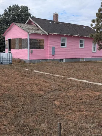 a front view of house with yard and trees