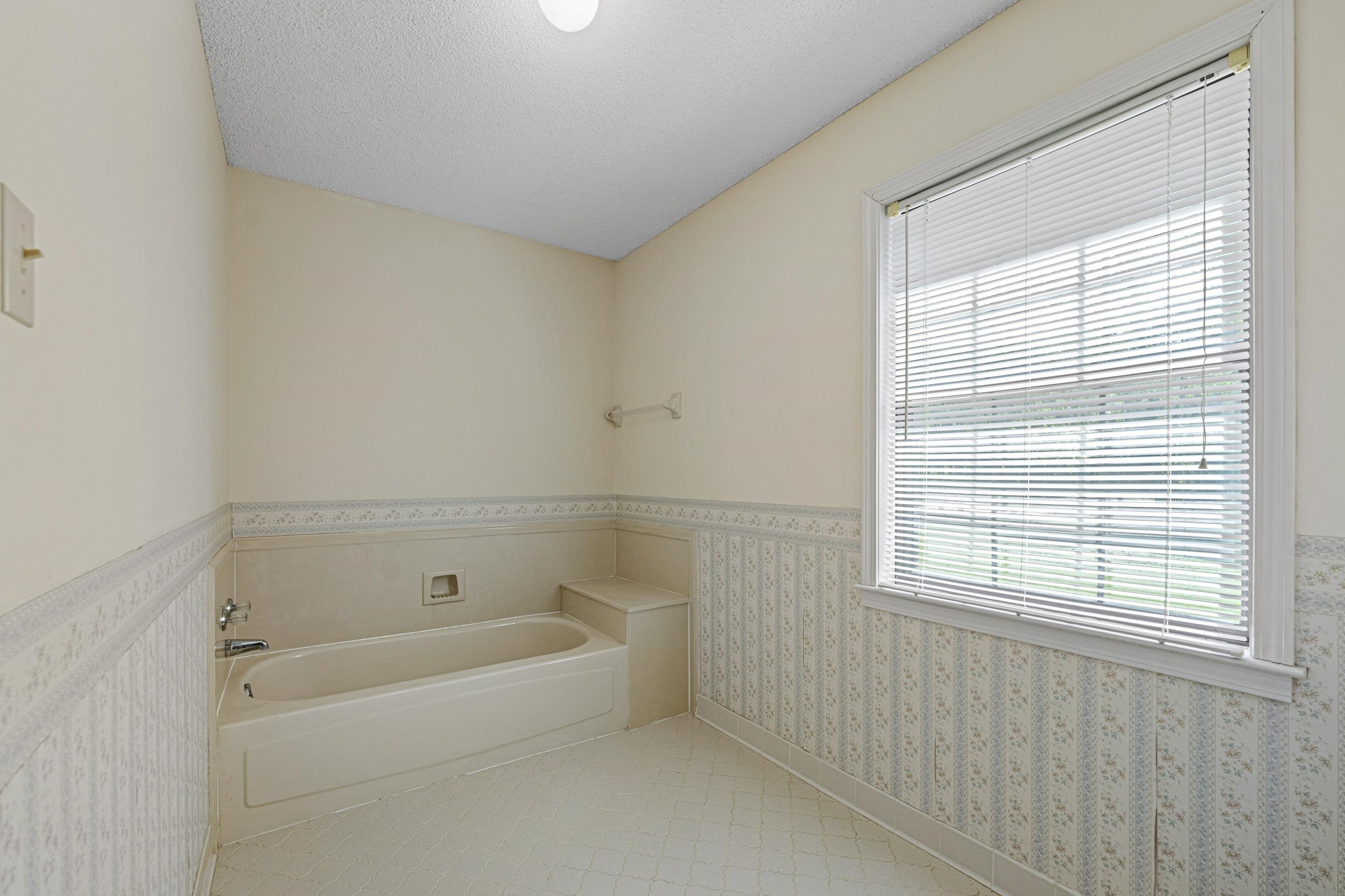 650 Blain Road Rossville, TN 38066 - Photo 16 of 26 A built-in bathtub creates a cozy place to soak and unwind, complemented by a convenient shelf behind for easy access to essentials. The space invites relaxation and offers the perfect foundation for future customization.