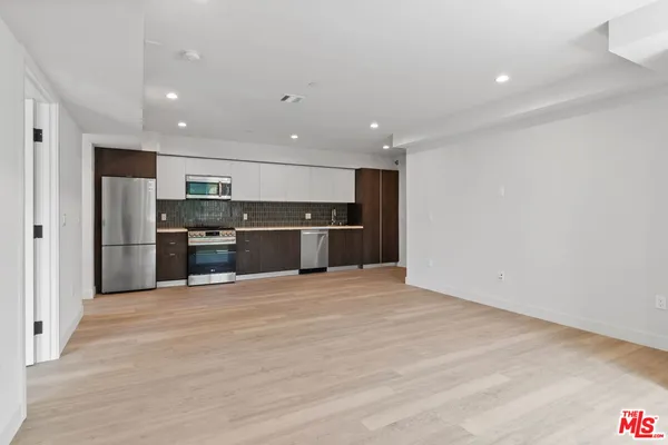 a view of kitchen with stainless steel appliances refrigerator and microwave