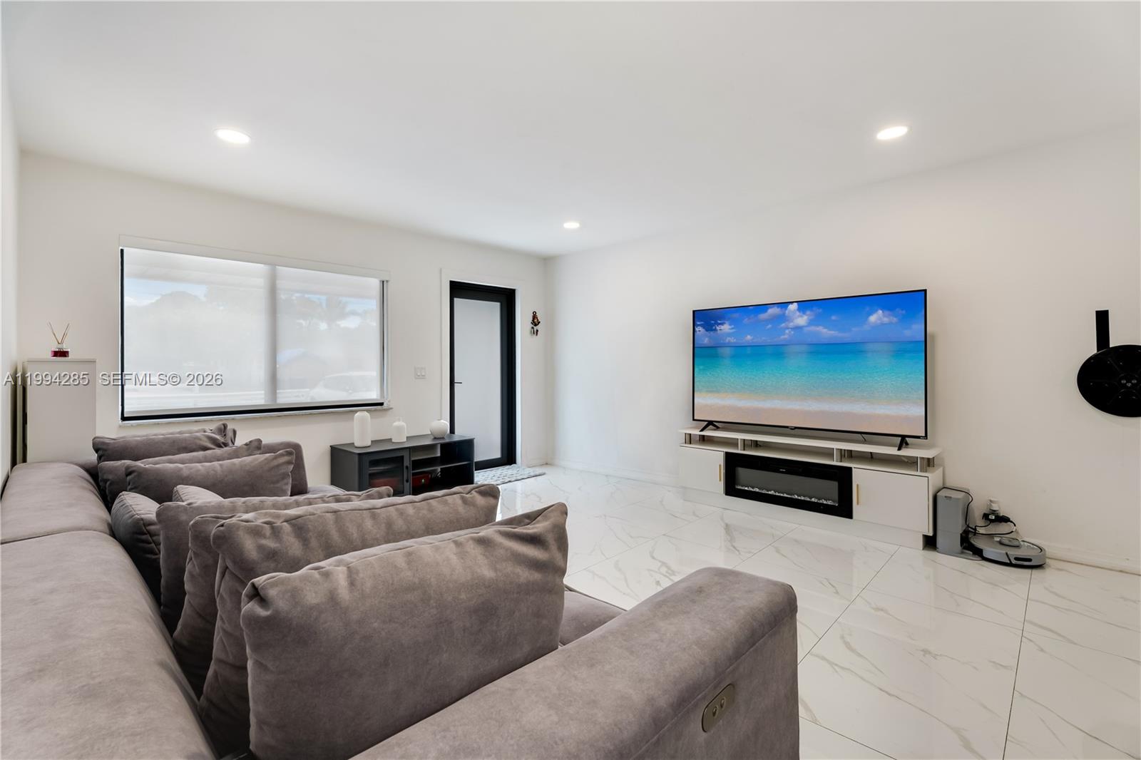 5635 Pierce Street Hollywood, FL 33021 - Photo 13 of 27 a living room with furniture and a flat screen tv