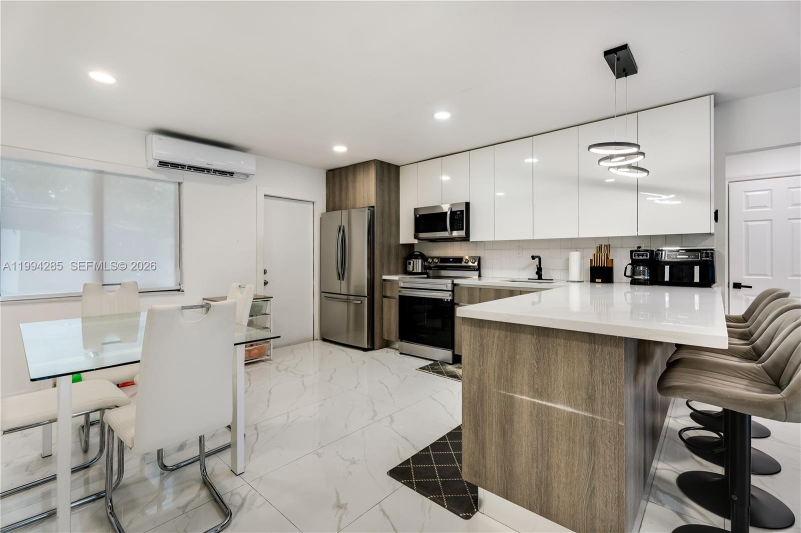 5635 Pierce Street Hollywood, FL 33021 - Photo 15 of 27 a kitchen with stainless steel appliances kitchen island granite countertop a sink and cabinets