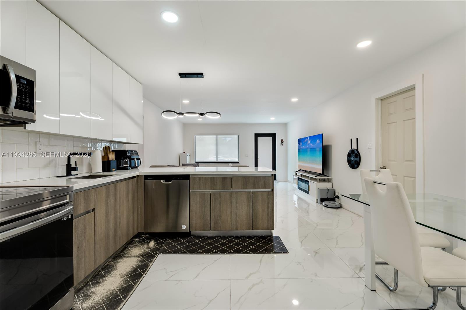 5635 Pierce Street Hollywood, FL 33021 - Photo 17 of 27 a kitchen with stainless steel appliances a stove a sink and a refrigerator