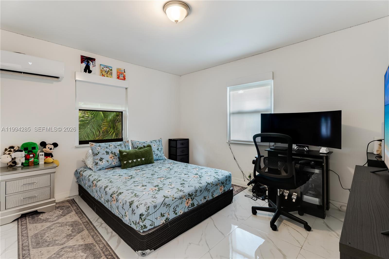 5635 Pierce Street Hollywood, FL 33021 - Photo 18 of 27 a bedroom with a bed and flat screen tv