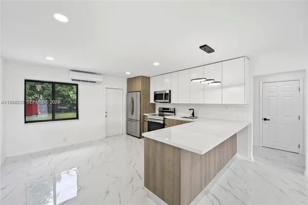 a large kitchen with kitchen island a stove a refrigerator a sink and dishwasher