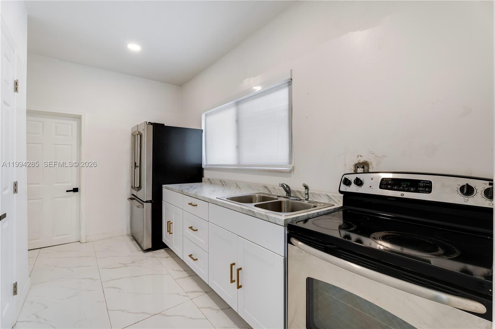 5635 Pierce Street Hollywood, FL 33021 - Photo 21 of 27 a kitchen with a stove and a refrigerator