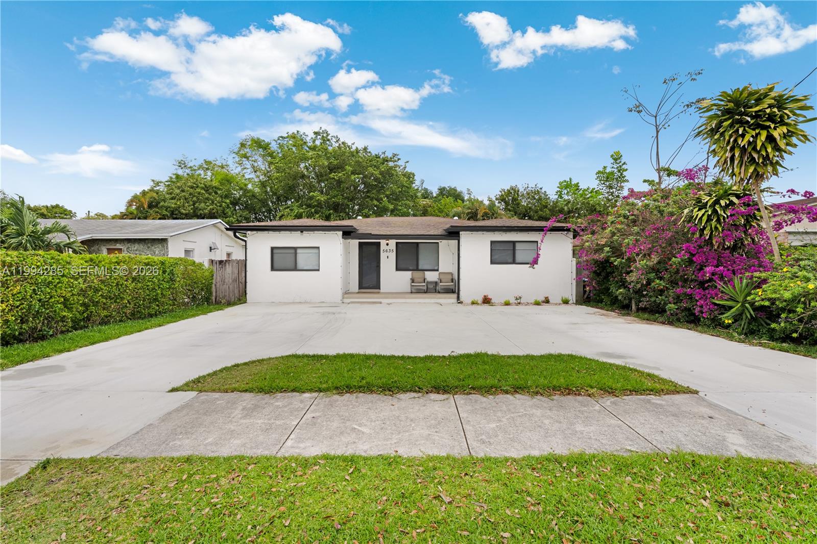 5635 Pierce Street Hollywood, FL 33021 - Photo 27 of 27 a front view of a house with a yard and potted plants