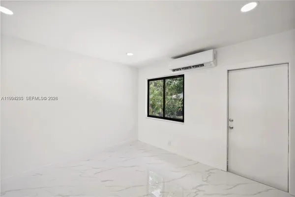 a view of an empty room with a window