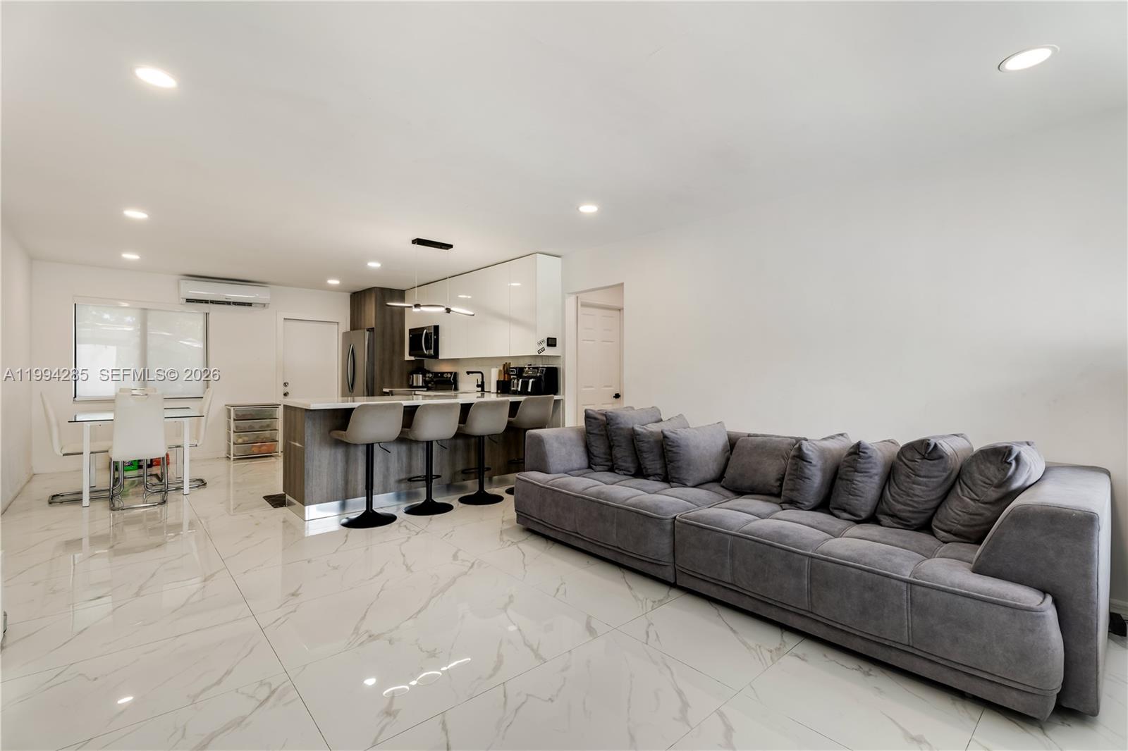 5635 Pierce Street Hollywood, FL 33021 - Photo 8 of 27 a living room with furniture and kitchen view