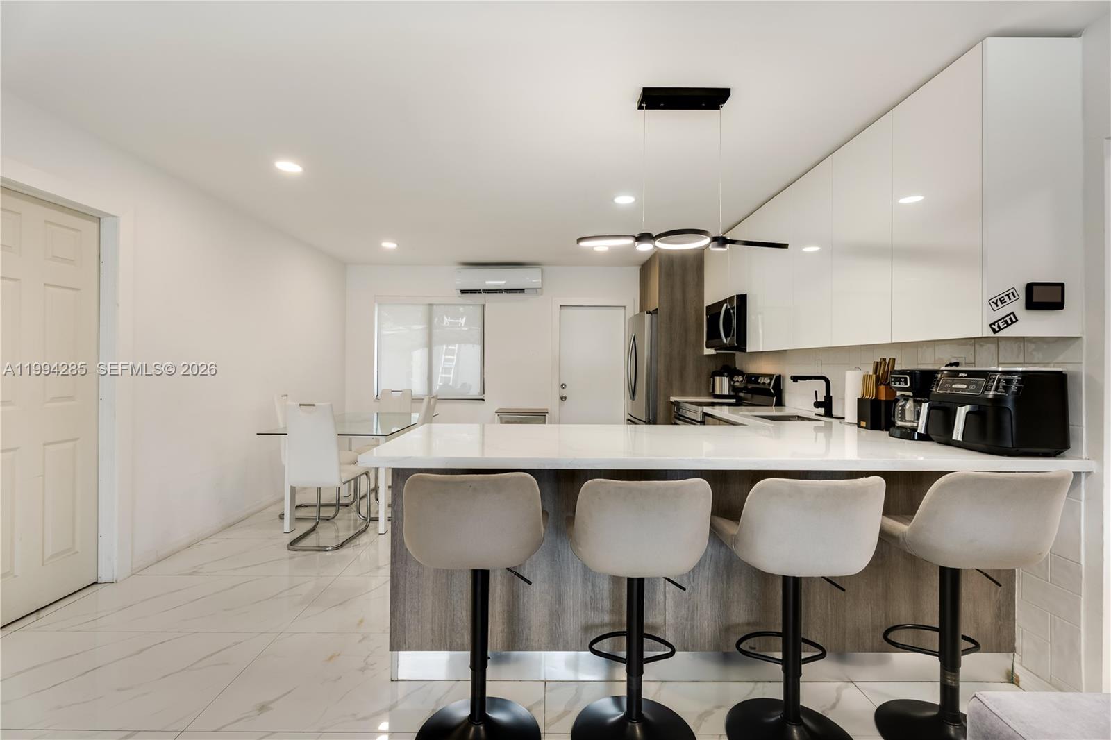 5635 Pierce Street Hollywood, FL 33021 - Photo 9 of 27 a kitchen with lots of counter space and chairs