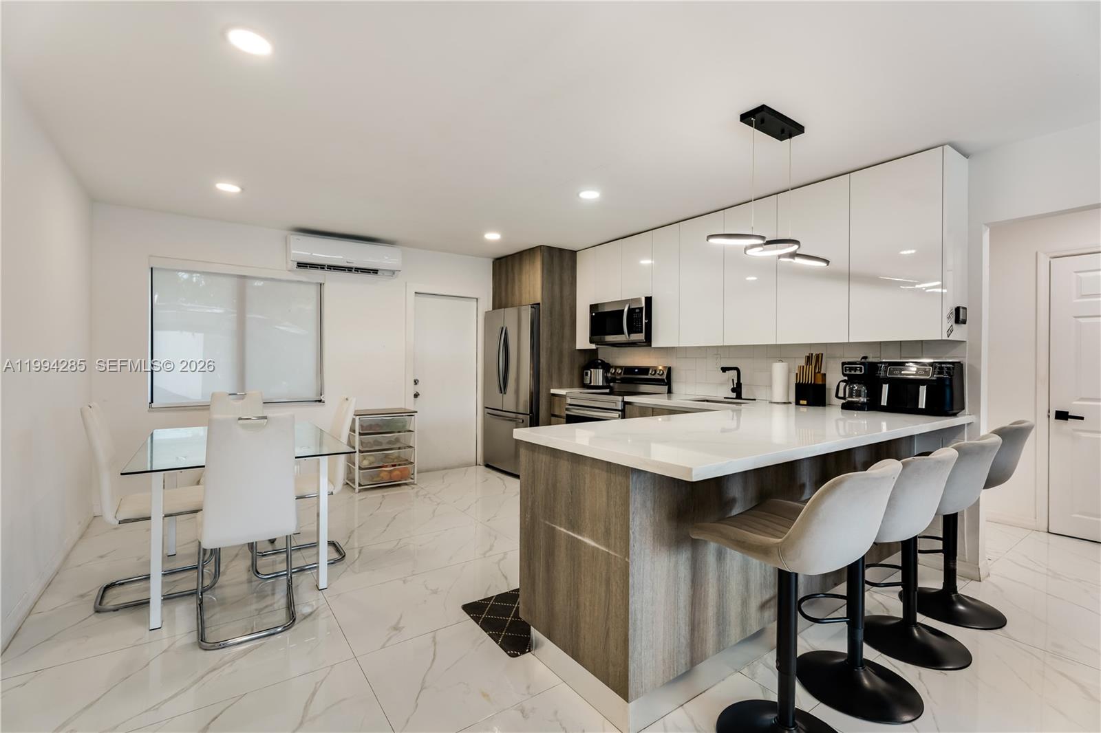 5635 Pierce Street Hollywood, FL 33021 - Photo 10 of 27 a kitchen with appliances cabinets and a sink