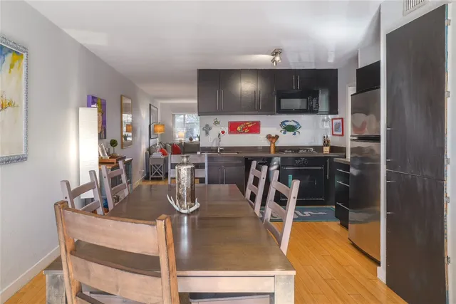 a dining room with furniture and wooden floor