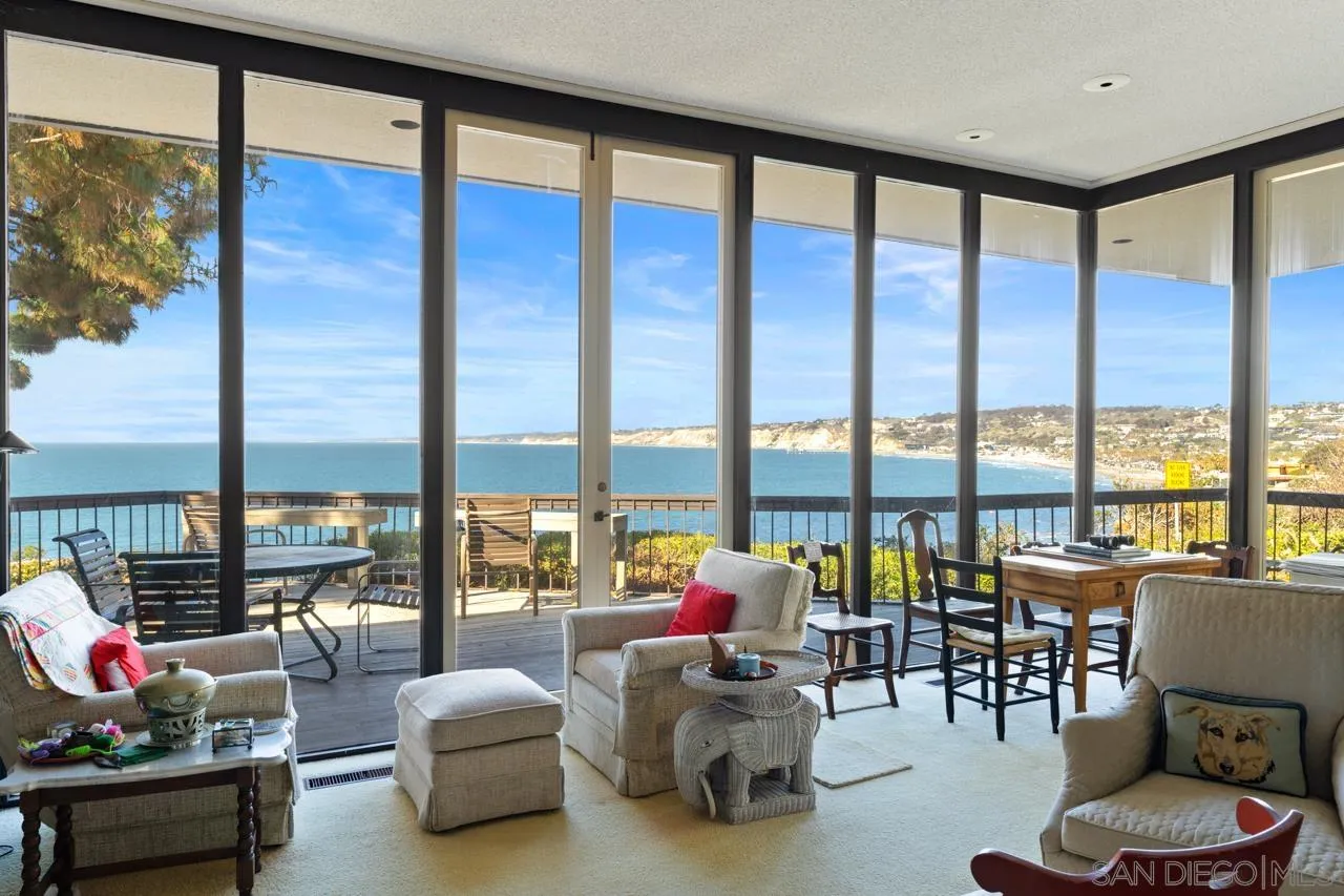 1595 Coast Walk La Jolla, CA 92037 - Photo 2 of 24 a living room with furniture and floor to ceiling windows