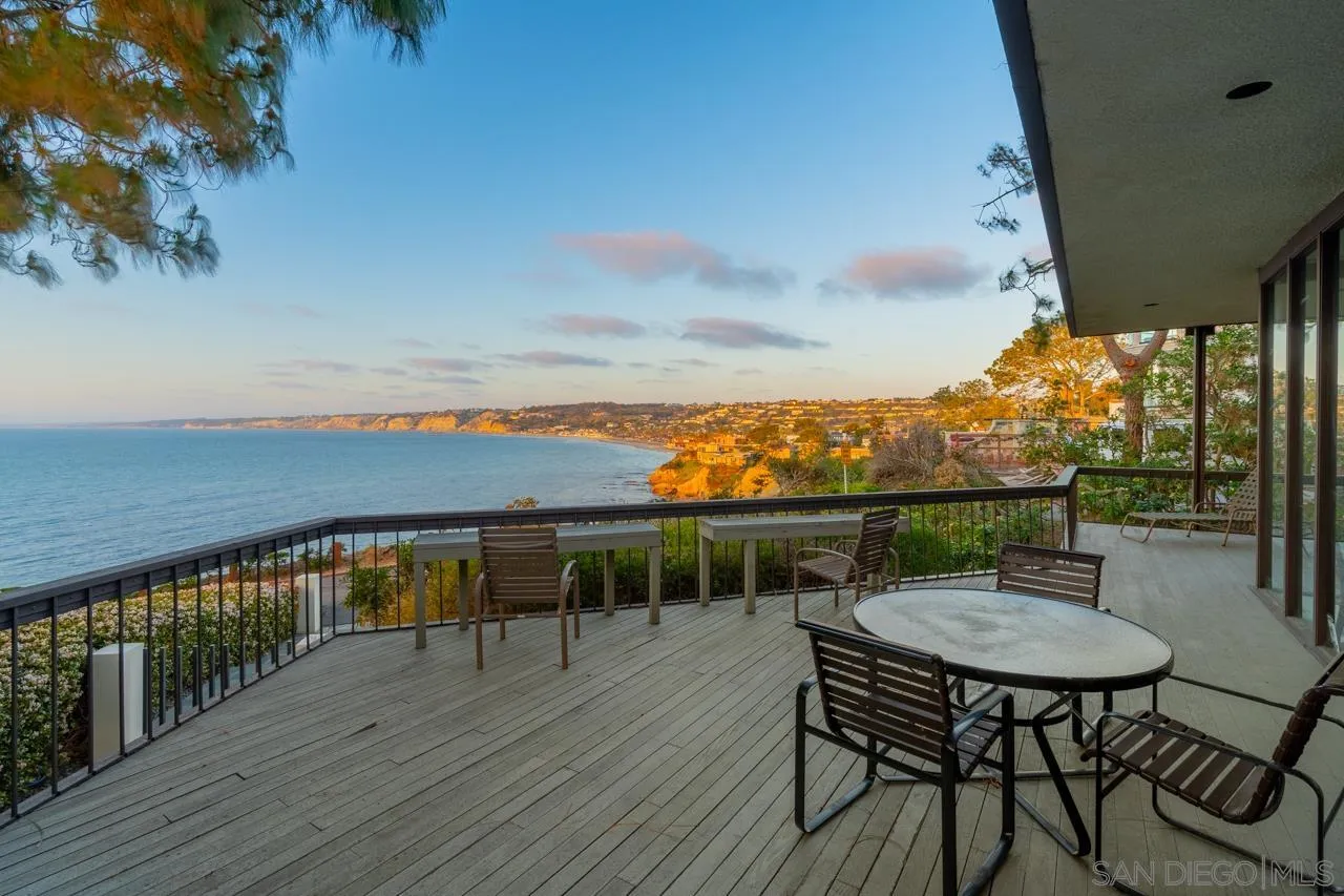1595 Coast Walk La Jolla, CA 92037 - Photo 3 of 24 a view of a chairs and table on the wooden deck