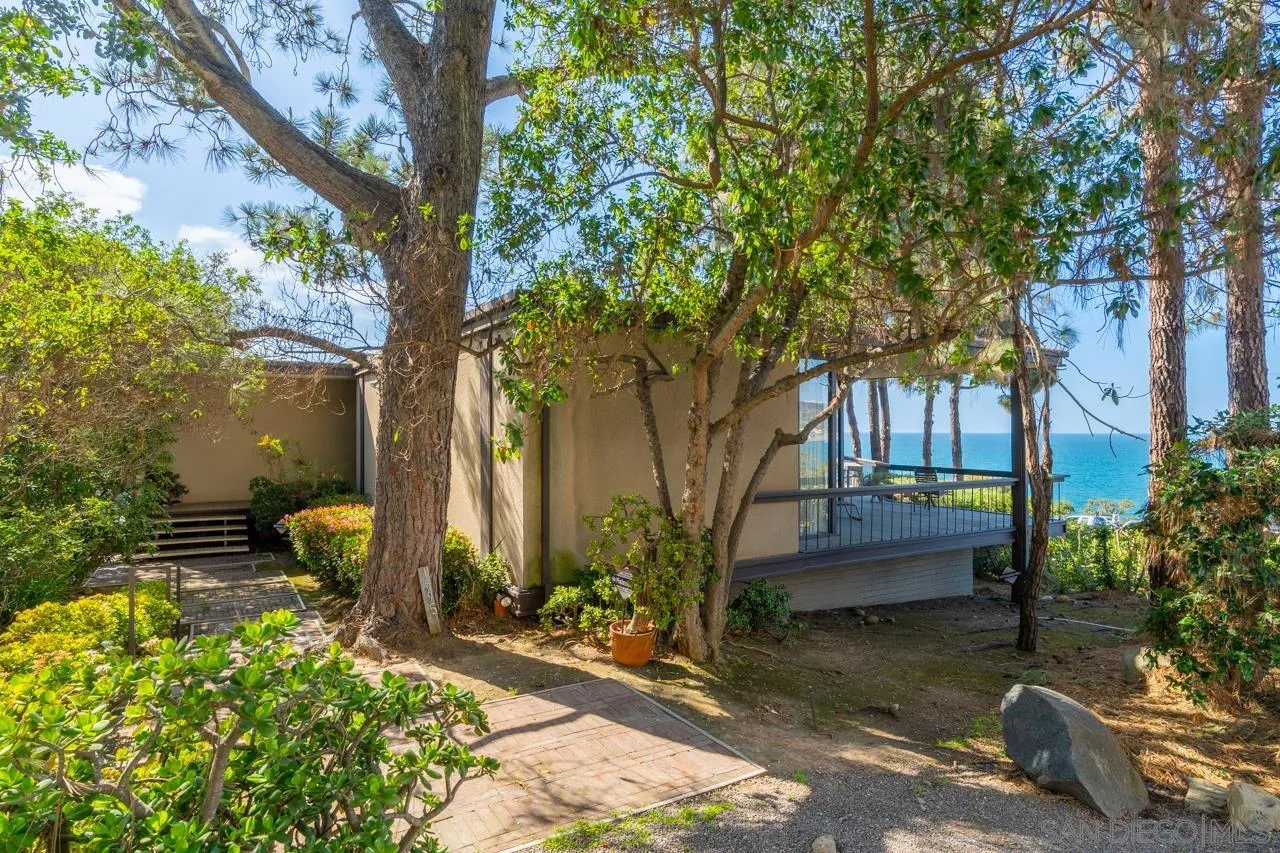1595 Coast Walk La Jolla, CA 92037 - Photo 9 of 24 a front view of a house with garden