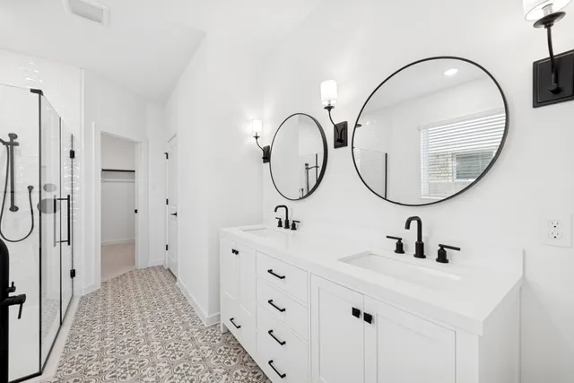 a bathroom with a sink mirror and a shower