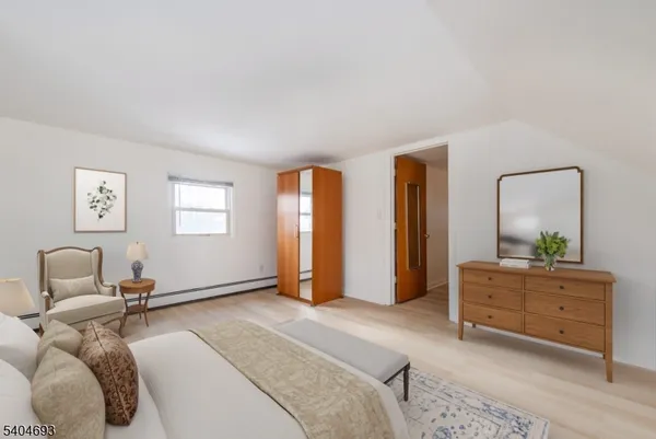 a bedroom with a bed and a dresser