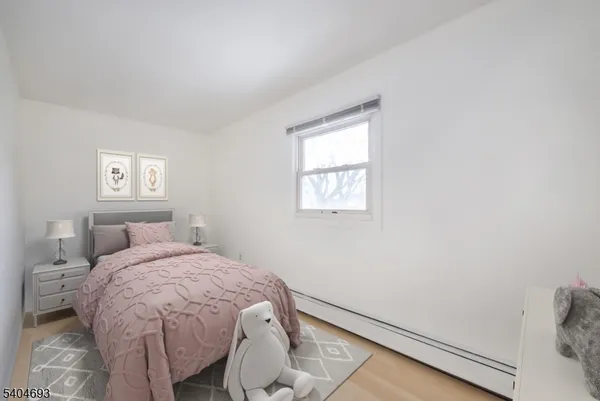 a bed sitting in a bedroom next to a window