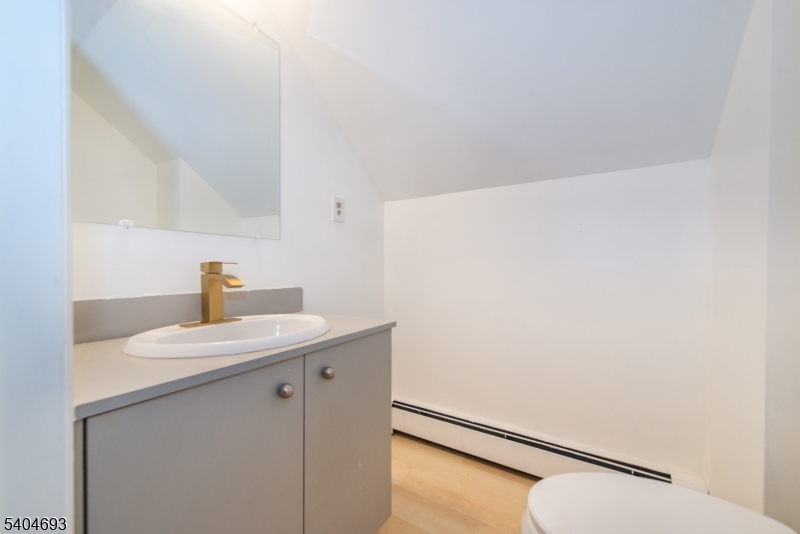 116 Edison Street Clifton, NJ 07013 - Photo 15 of 19 a bathroom with a sink and a mirror