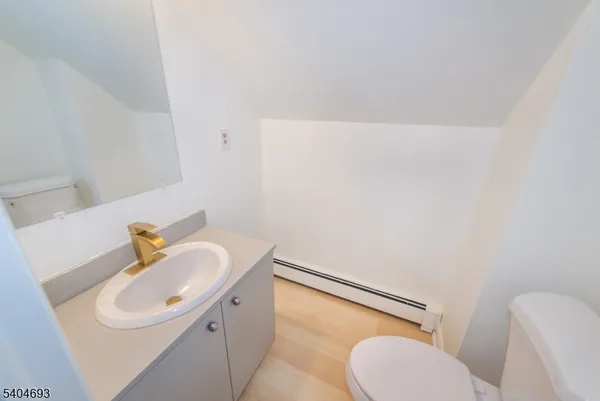 a bathroom with a sink a toilet and mirror