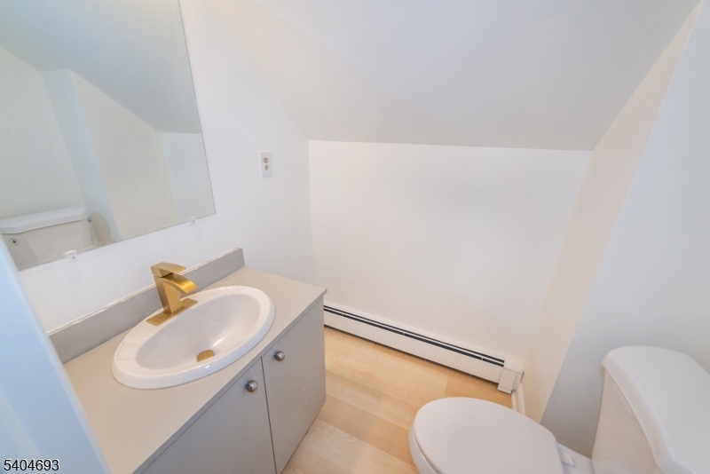 116 Edison Street Clifton, NJ 07013 - Photo 16 of 19 a bathroom with a sink a toilet and mirror