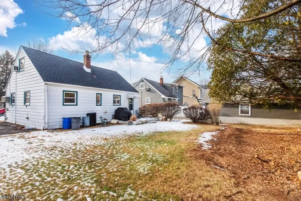 a view of a house with a yard covered in snow