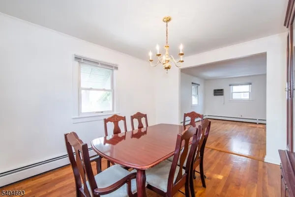 a view of a dining room with furniture and chandelier