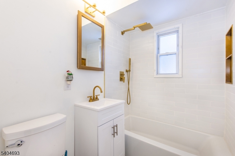 116 Edison Street Clifton, NJ 07013 - Photo 7 of 19 a bathroom with a sink a toilet and a bathtub