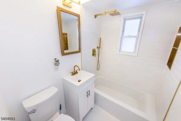 a bathroom with a sink a toilet and bathtub
