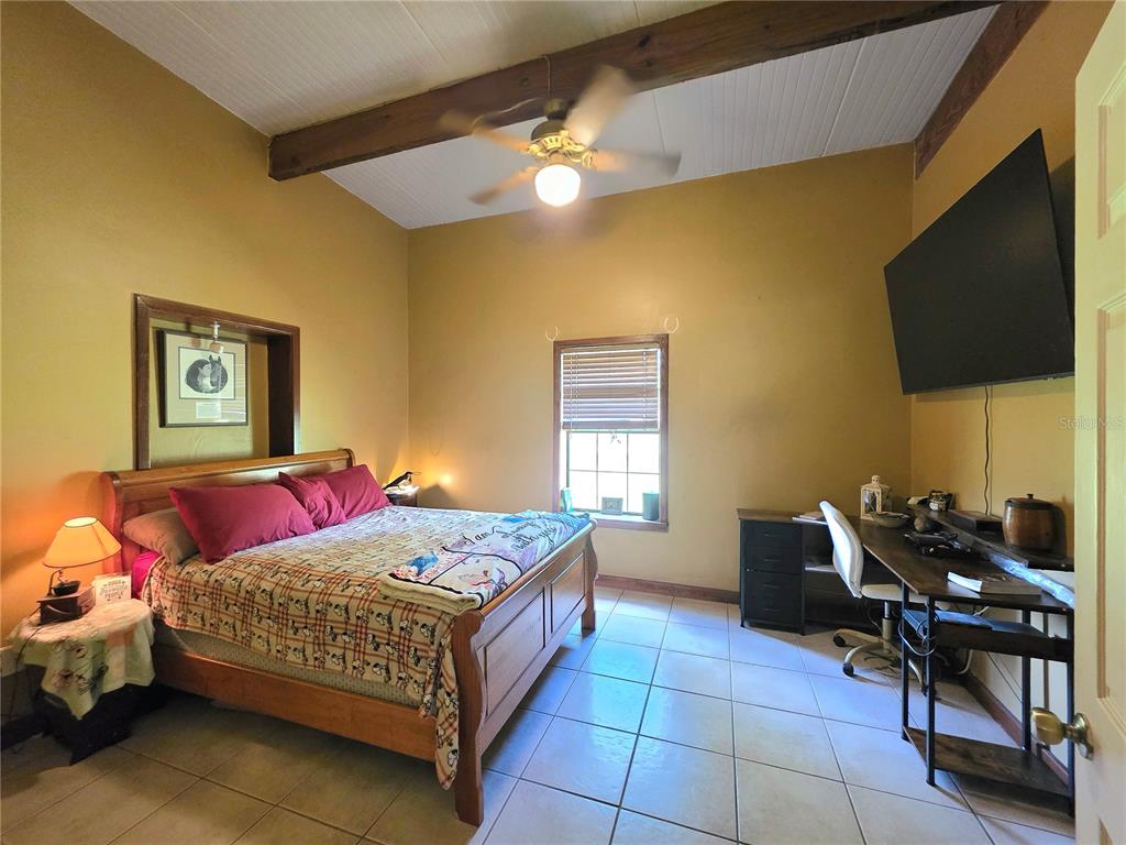 54523 Astor Transfer Station Road Astor, FL 32102 - Photo 11 of 31 a bedroom with a bed and a flat screen tv