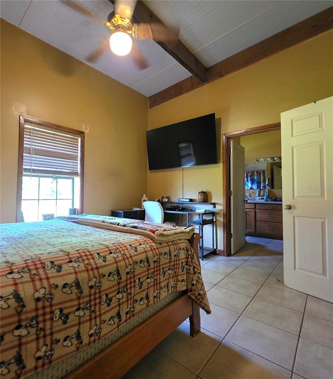 54523 Astor Transfer Station Road Astor, FL 32102 - Photo 12 of 31 a bedroom with a bed and a flat screen tv
