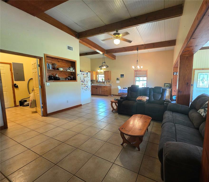 54523 Astor Transfer Station Road Astor, FL 32102 - Photo 5 of 31 a living room with furniture and a flat screen tv