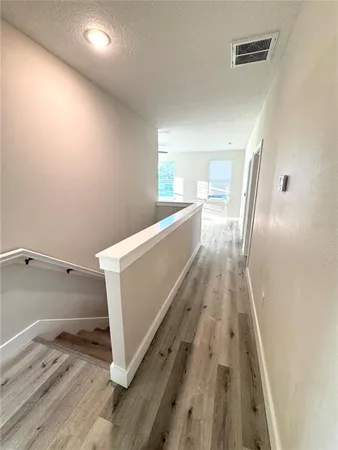 a view of a kitchen with wooden floor