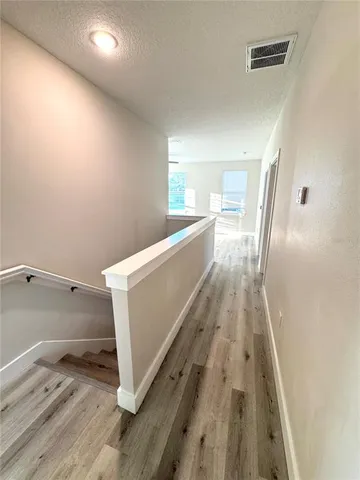 a view of a kitchen with wooden floor
