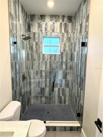 a bathroom with a toilet and shower
