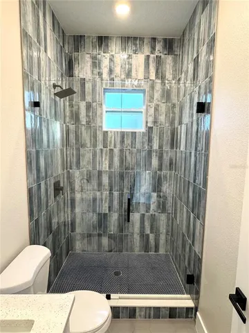 a bathroom with a toilet and shower