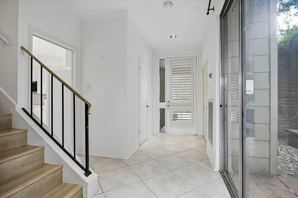 a view of a hallway with wooden floor and entryway