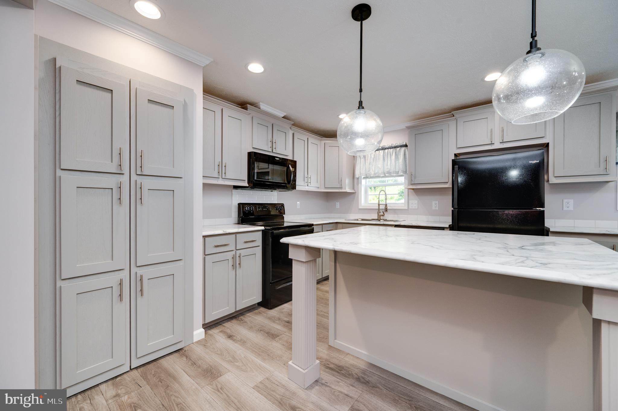 875 Mohrsville Road Shoemakersville, PA 19555 - Photo 14 of 34 a kitchen with kitchen island a counter space a sink appliances and cabinets