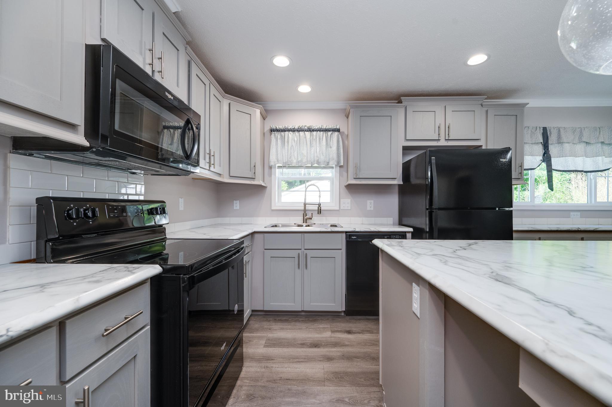 875 Mohrsville Road Shoemakersville, PA 19555 - Photo 16 of 34 a kitchen with stainless steel appliances granite countertop a sink stove and refrigerator