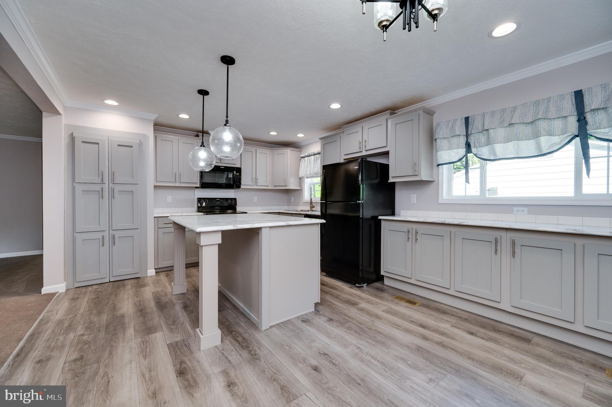 875 Mohrsville Road Shoemakersville, PA 19555 - Photo 20 of 34 a kitchen with kitchen island white cabinets and refrigerator
