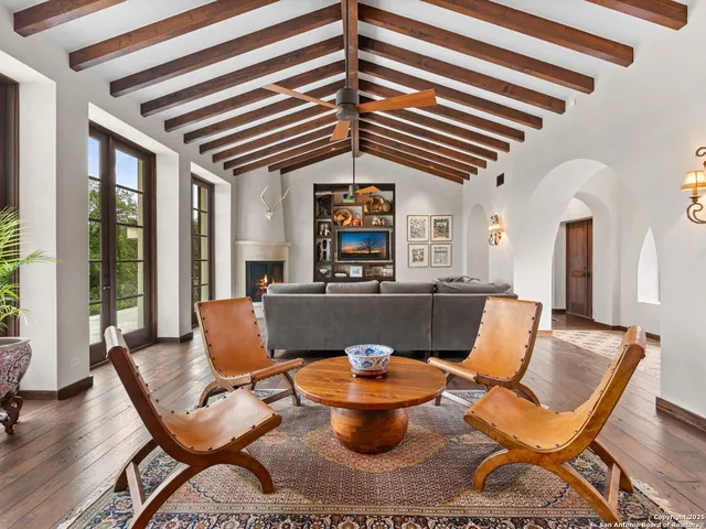 a view of hall way with furniture and wooden floor